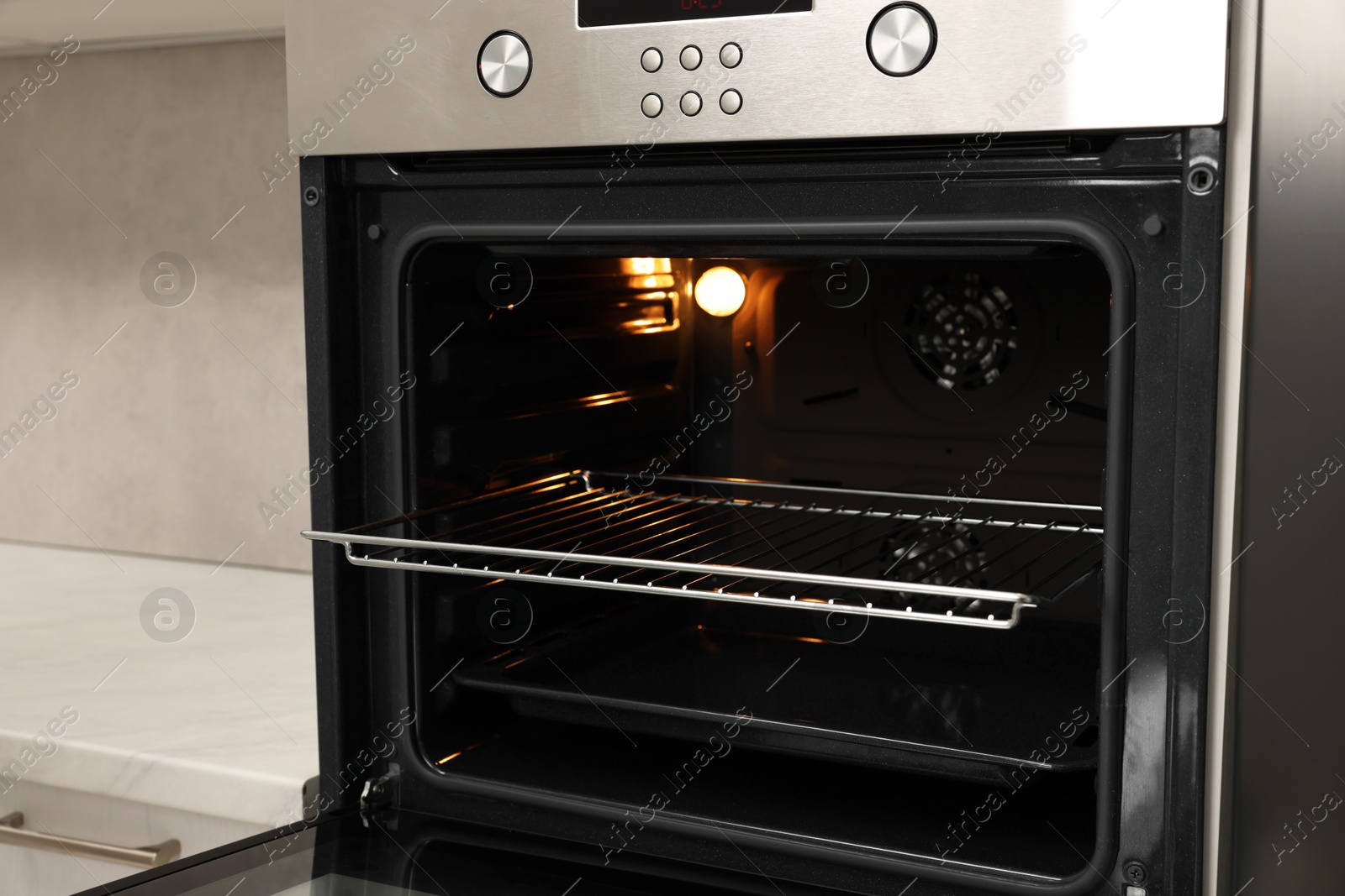 Photo of Open electric oven in kitchen. Cooking appliance