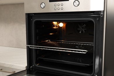 Photo of Open electric oven in kitchen. Cooking appliance