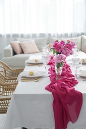 Photo of Beautiful table setting with pink peonies in dining room