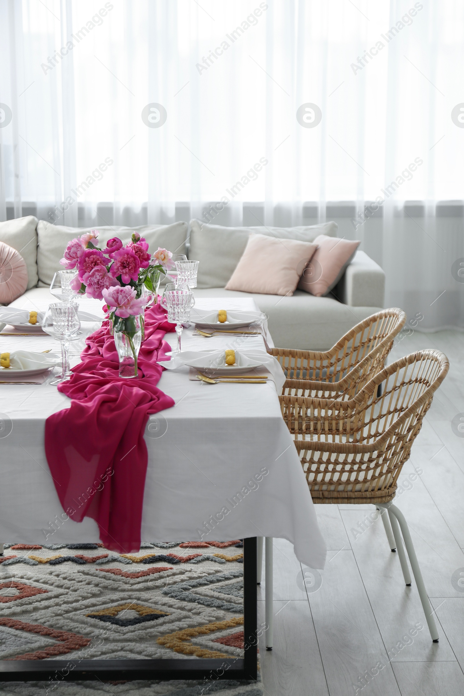 Photo of Beautiful table setting with pink peonies in dining room