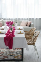 Photo of Beautiful table setting with pink peonies in dining room