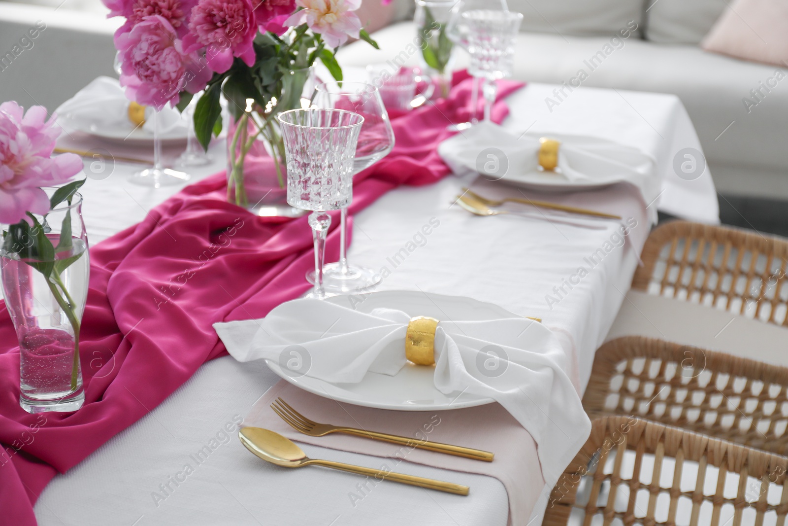 Photo of Beautiful table setting with pink peonies in dining room