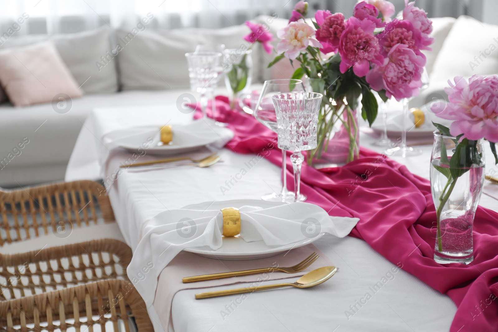 Photo of Beautiful table setting with pink peonies in dining room