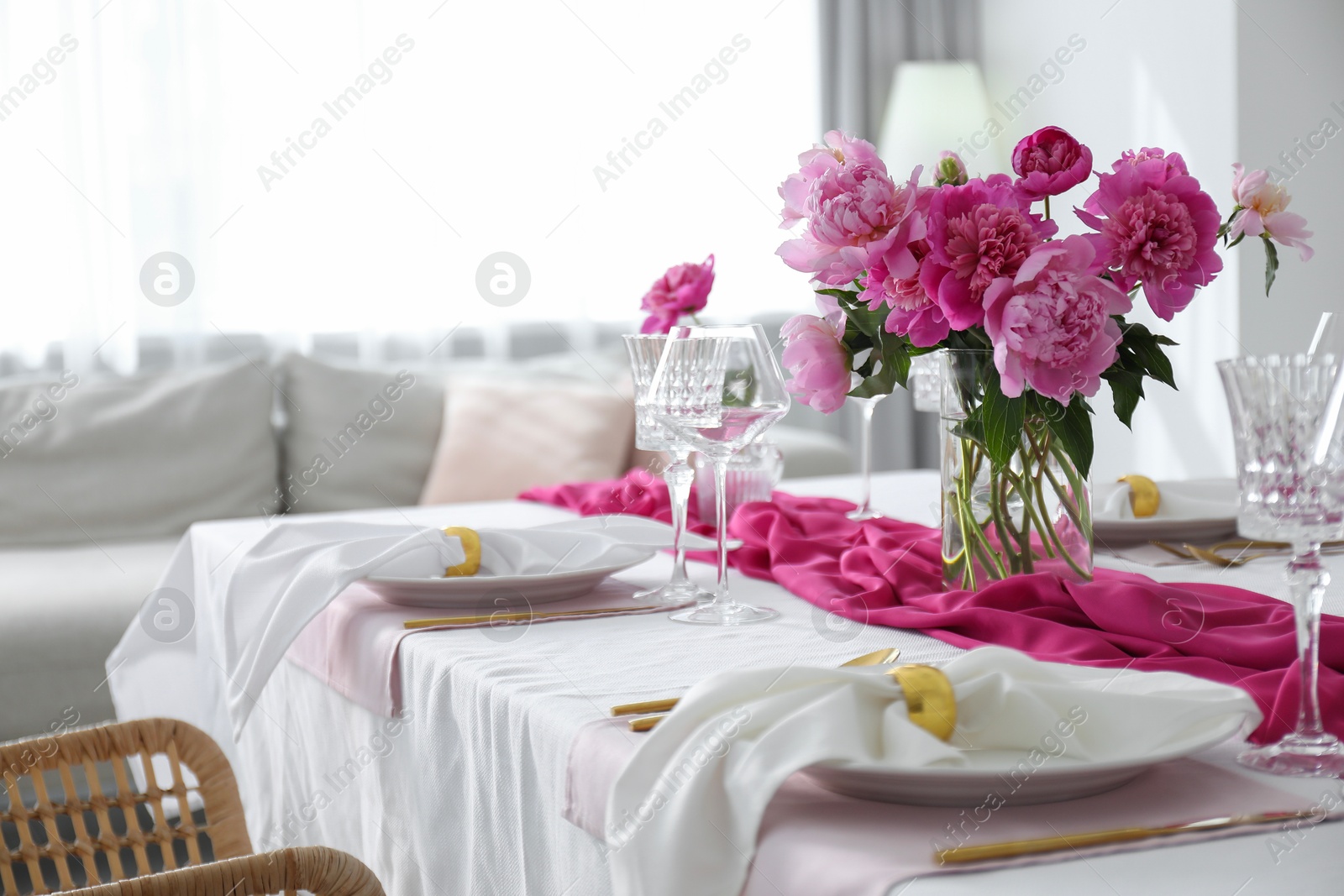 Photo of Beautiful table setting with pink peonies in dining room