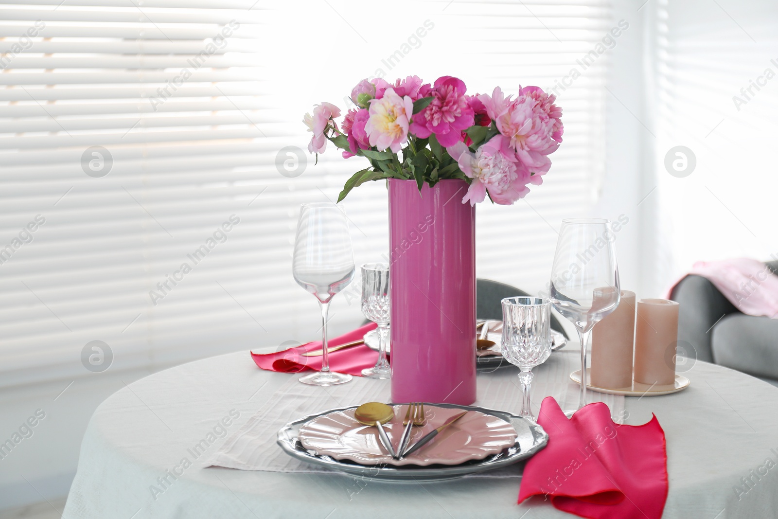 Photo of Beautiful table setting with pink peonies and candles