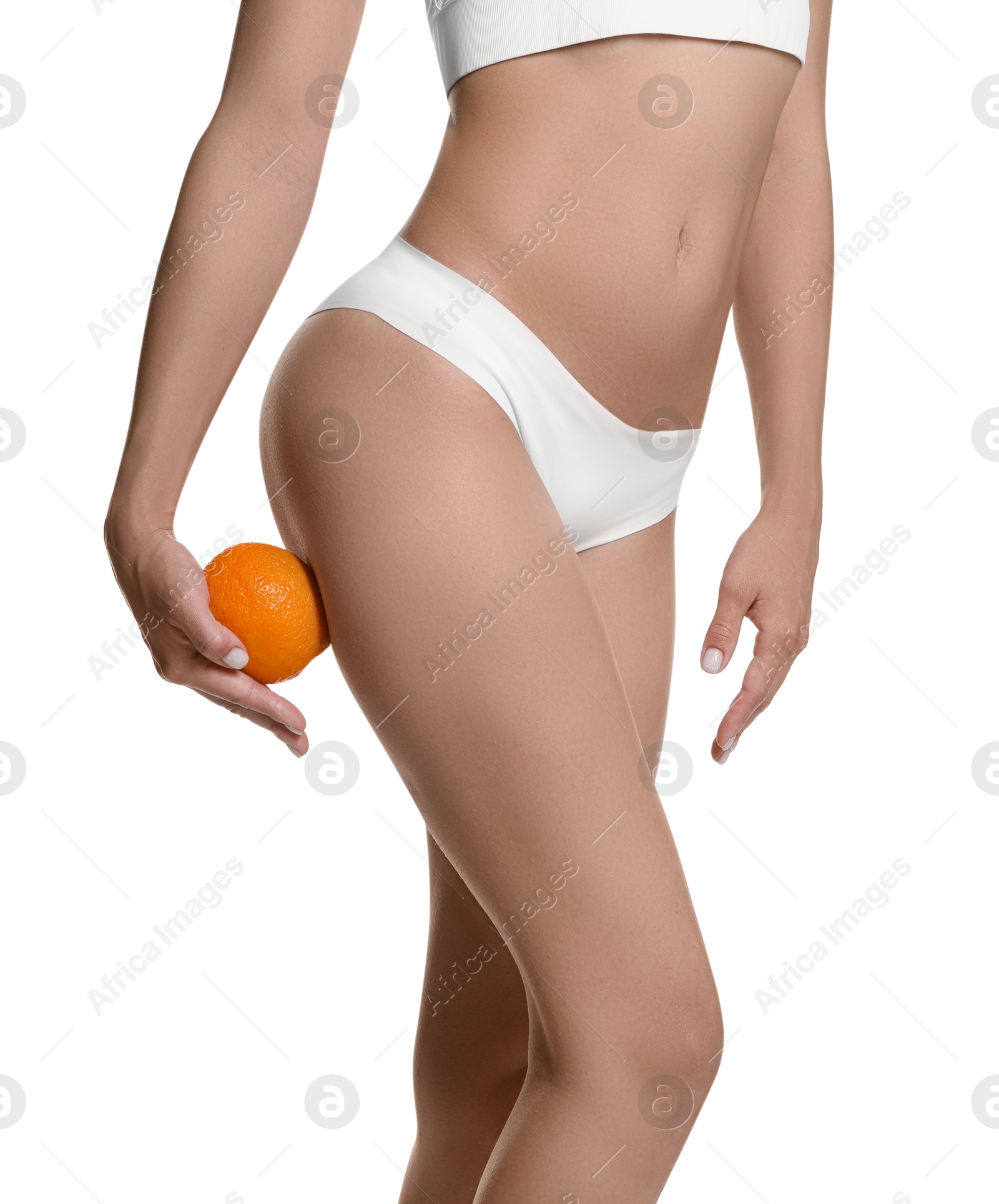 Photo of Woman in underwear with orange on white background, closeup. Cellulite problem