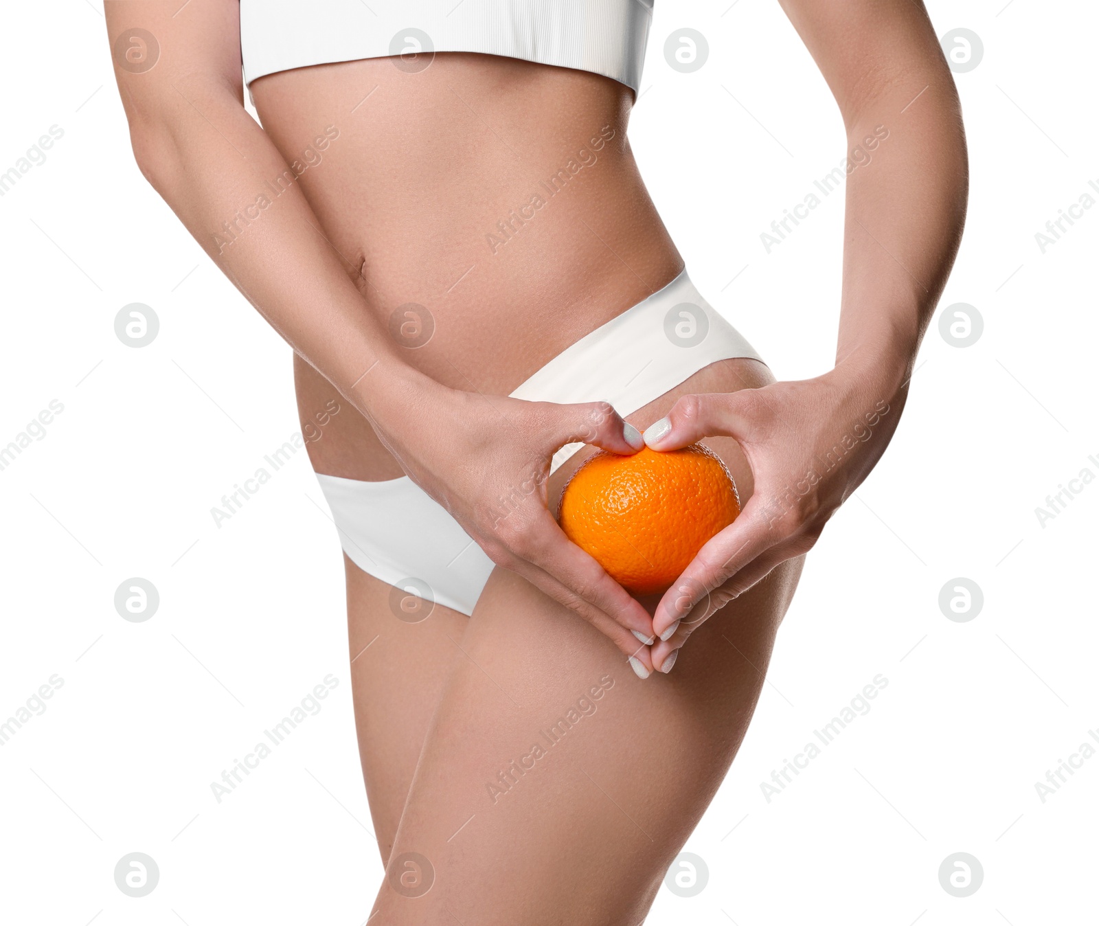 Photo of Woman in underwear with orange on white background, closeup. Cellulite problem