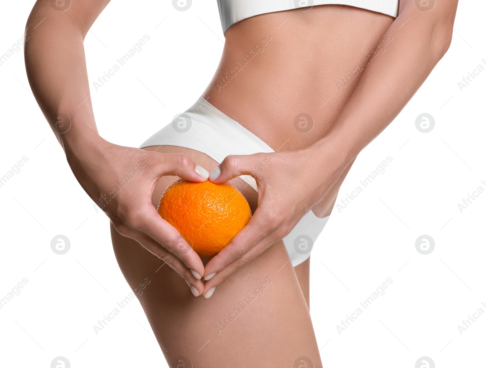 Photo of Woman in underwear with orange on white background, closeup. Cellulite problem