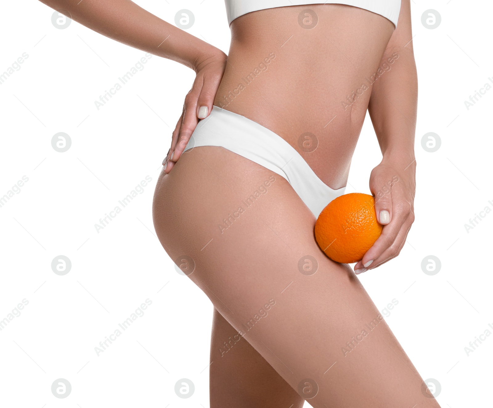 Photo of Woman in underwear with orange on white background, closeup. Cellulite problem