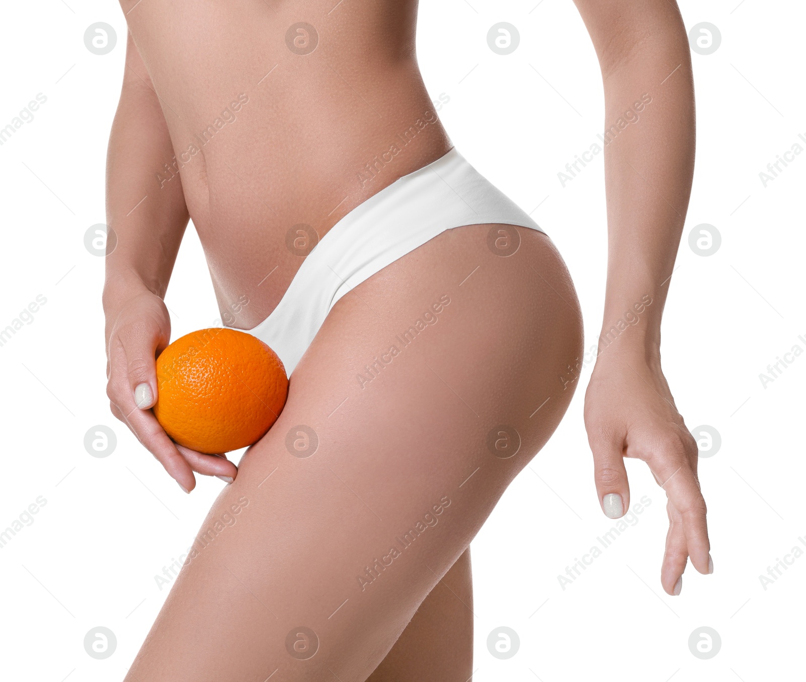 Photo of Woman in underwear with orange on white background, closeup. Cellulite problem