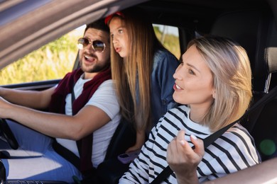 Photo of Happy family singing in car, view from outside