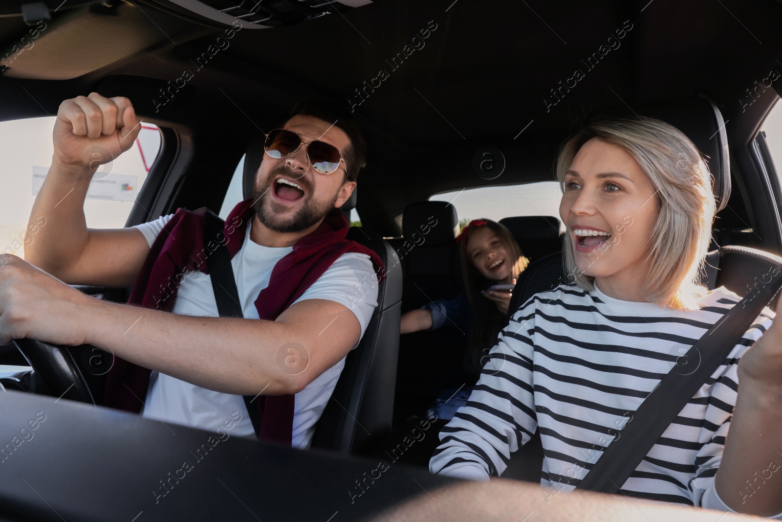 Photo of Happy family singing in car, view from inside