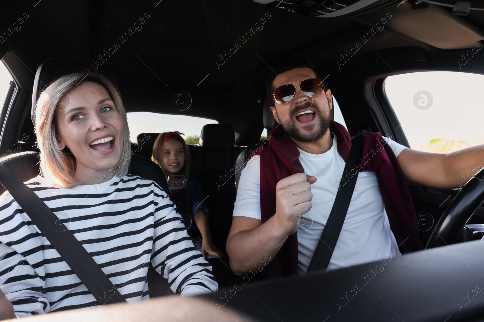 Photo of Happy family singing in car, view from inside