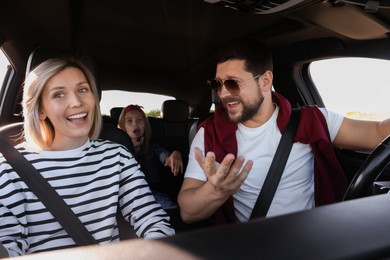 Photo of Happy family singing in car, view from inside