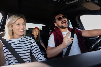 Photo of Happy family singing in car, view from inside