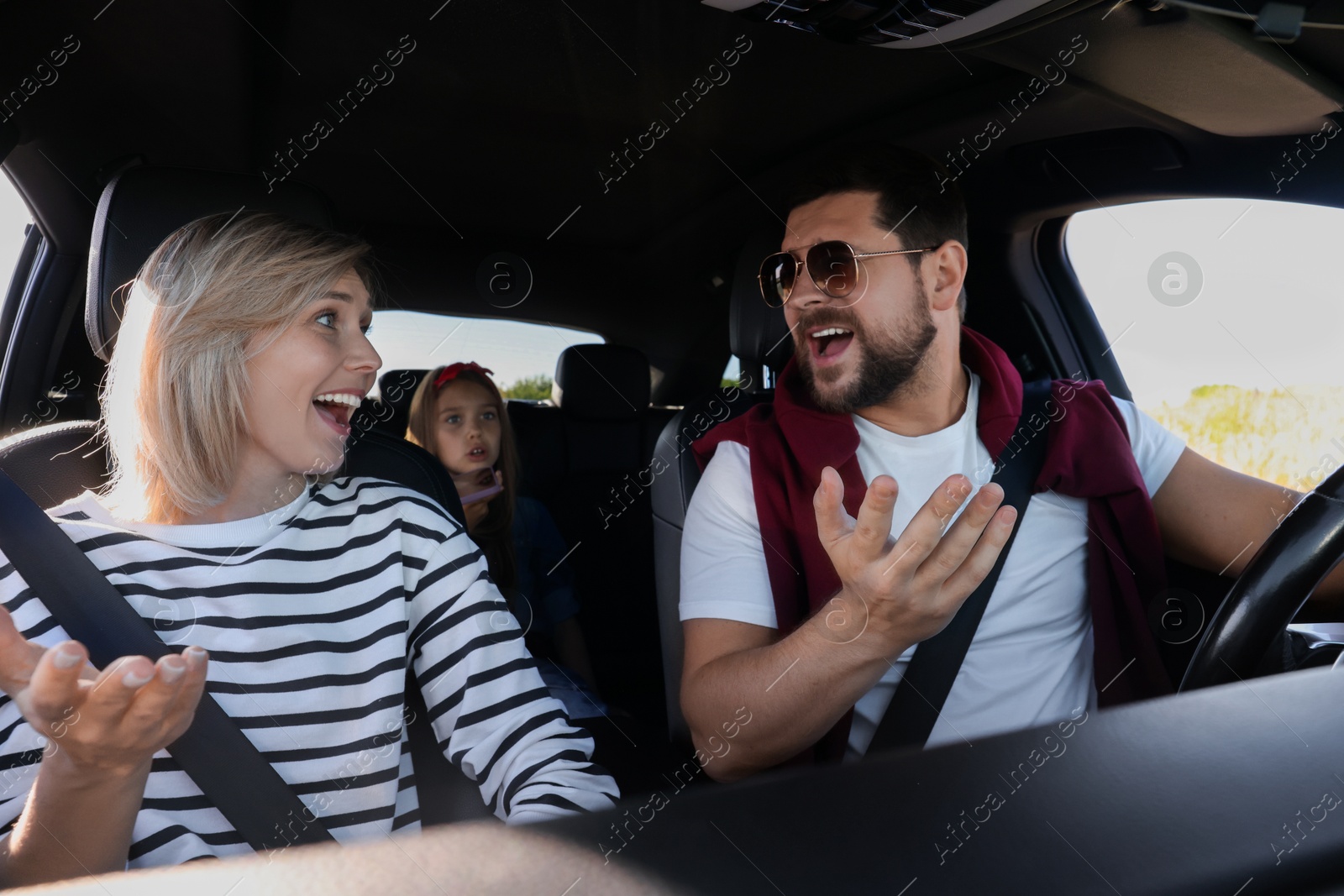 Photo of Happy family singing in car, view from inside