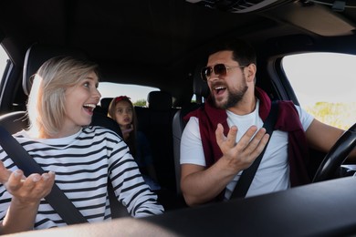 Happy family singing in car, view from inside