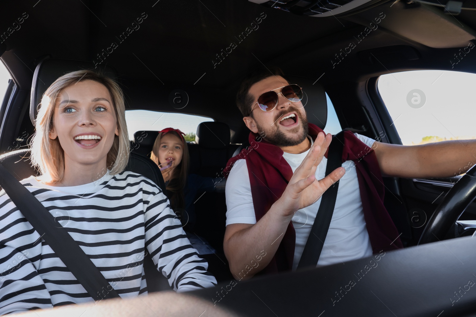 Photo of Happy family singing in car, view from inside