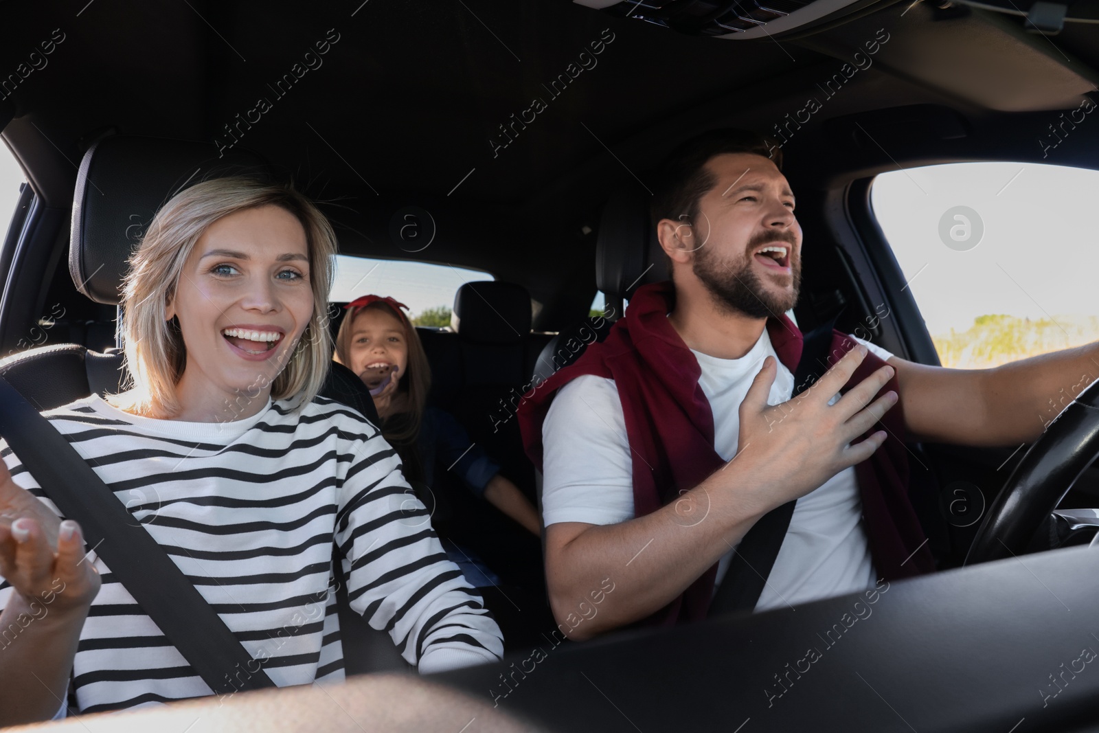 Photo of Happy family singing in car, view from inside