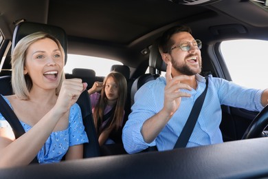 Photo of Happy family singing in car, view from inside