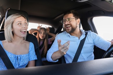 Photo of Happy family singing in car, view from inside