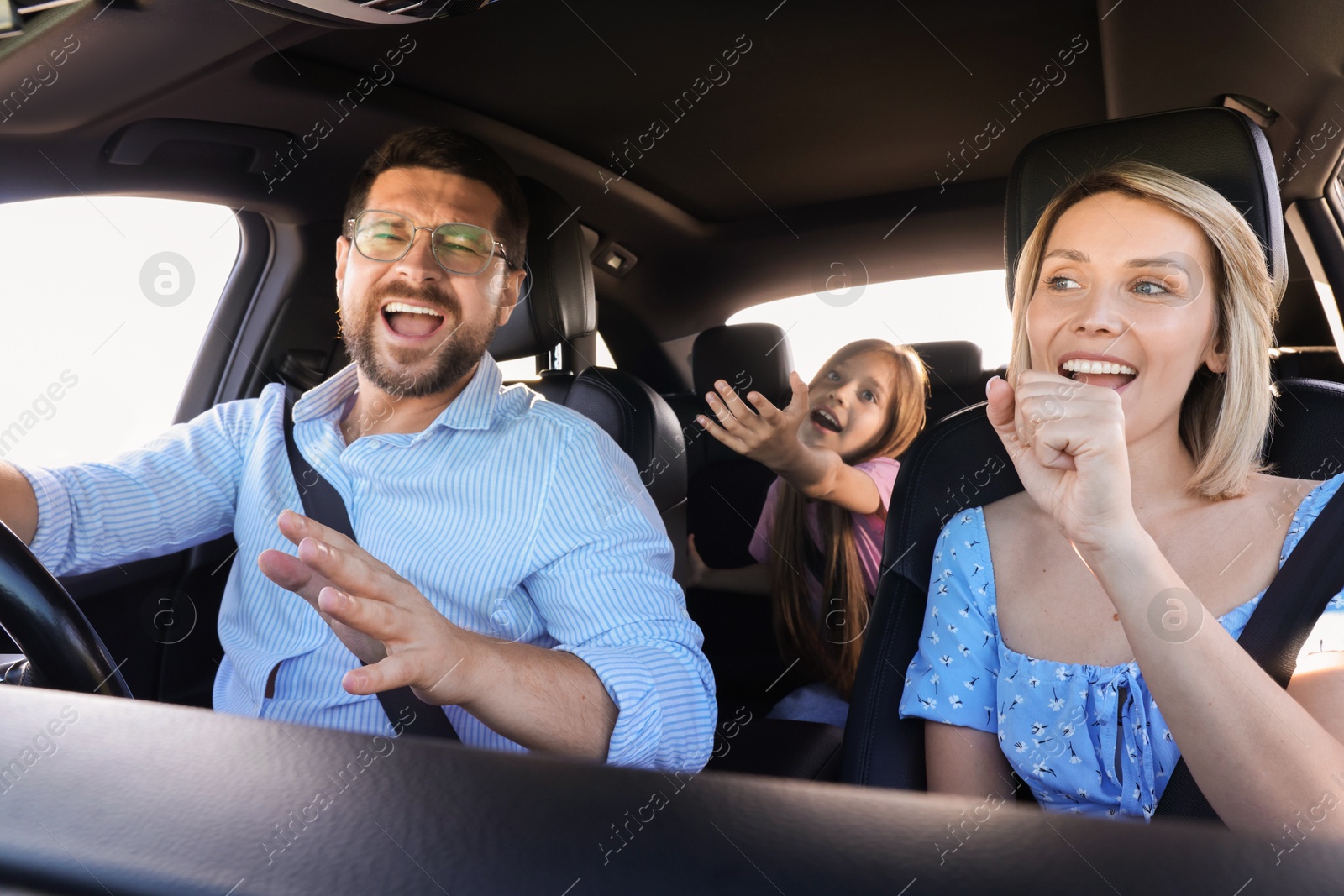 Photo of Happy family singing in car, view from inside