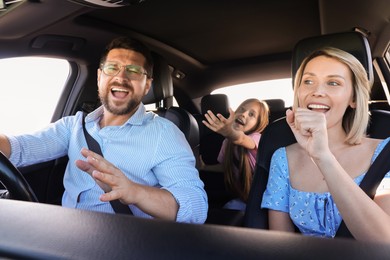 Photo of Happy family singing in car, view from inside