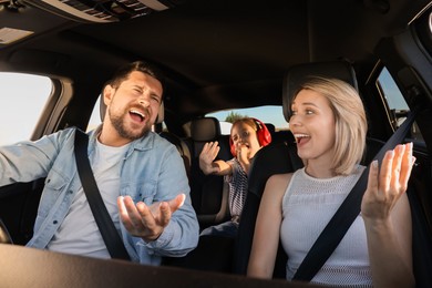 Happy family singing in car, view from inside