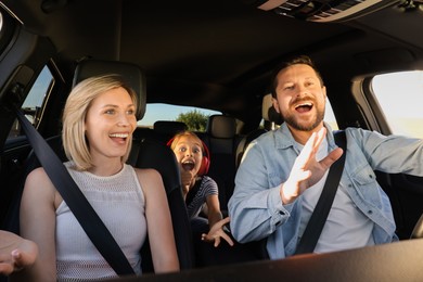 Photo of Happy family singing in car, view from inside