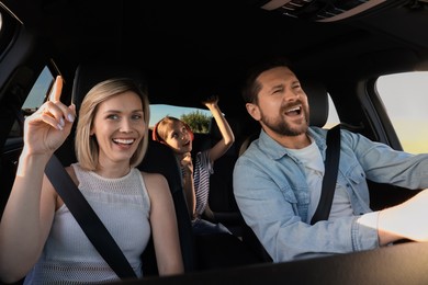 Happy family singing in car, view from inside