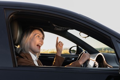 Photo of Woman singing in car, view from outside