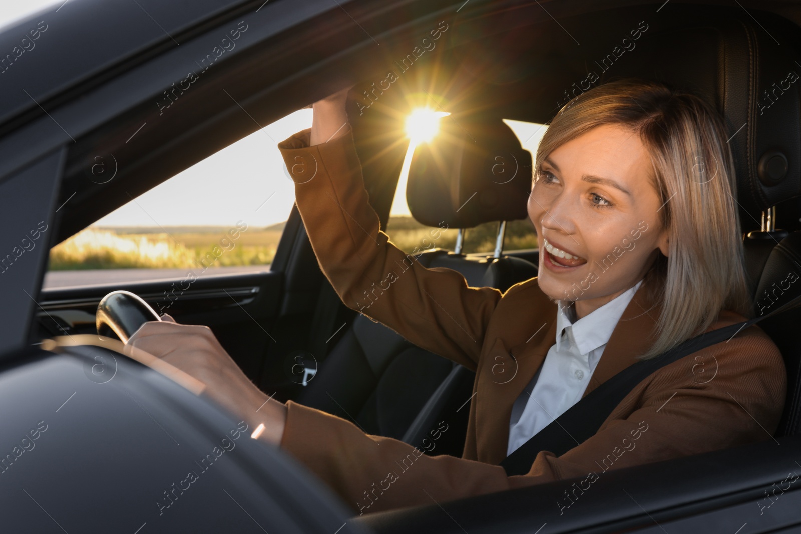 Photo of Woman singing in car, view from outside