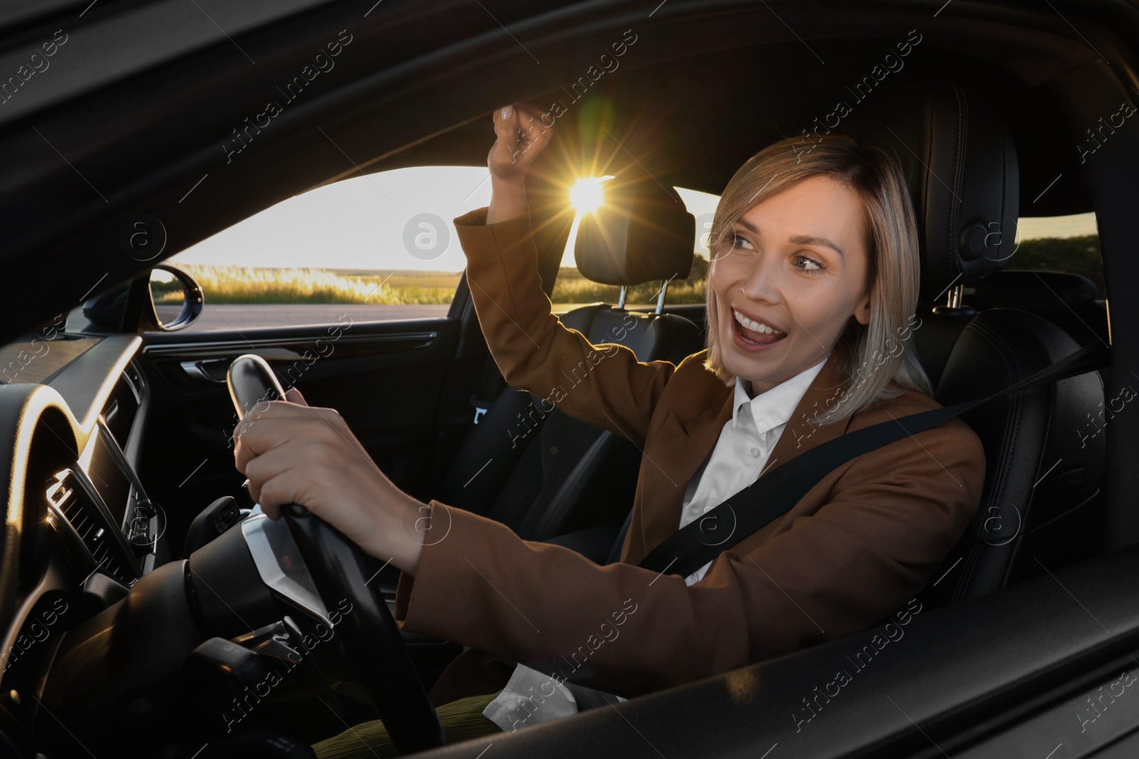 Photo of Woman singing in car, view from outside