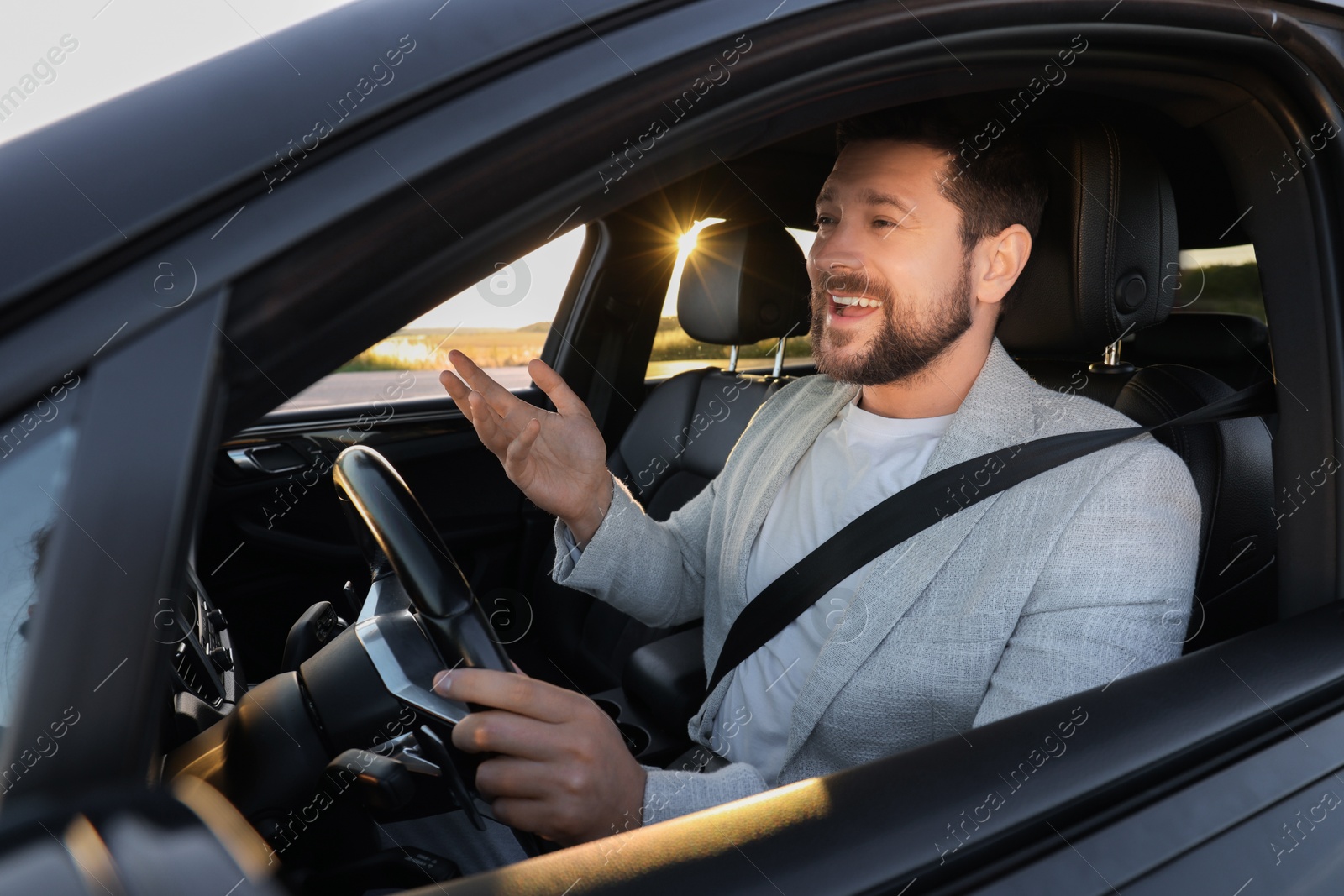 Photo of Man singing in car, view from outside