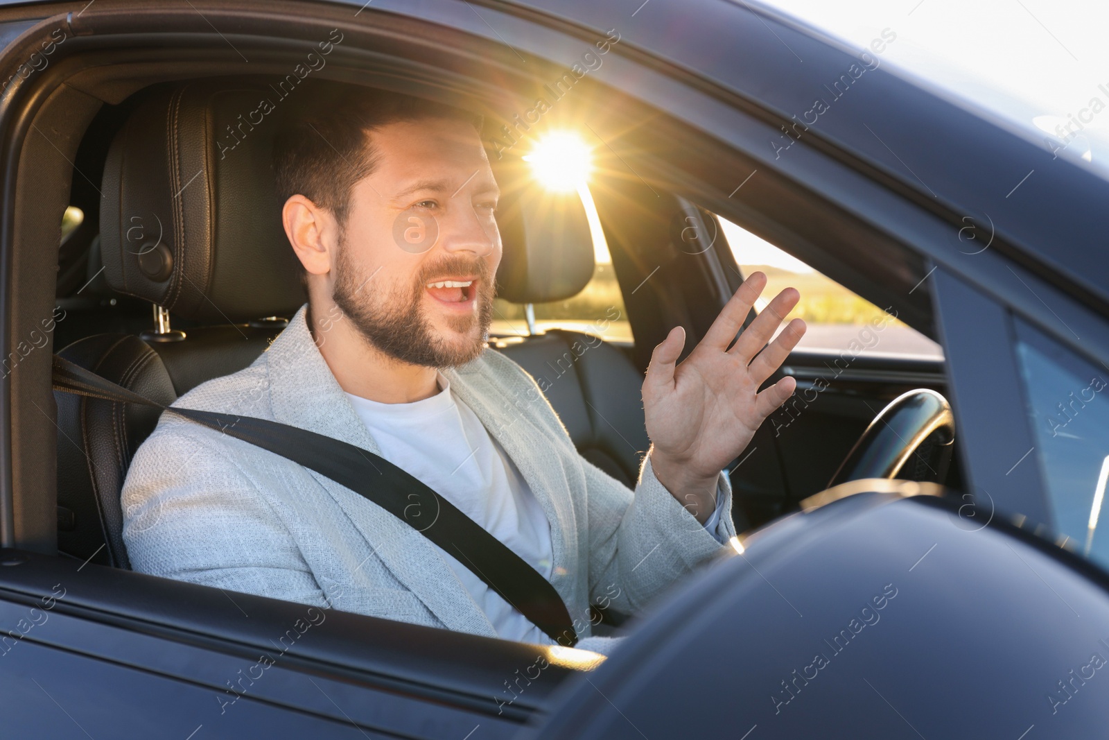 Photo of Man singing in car, view from outside