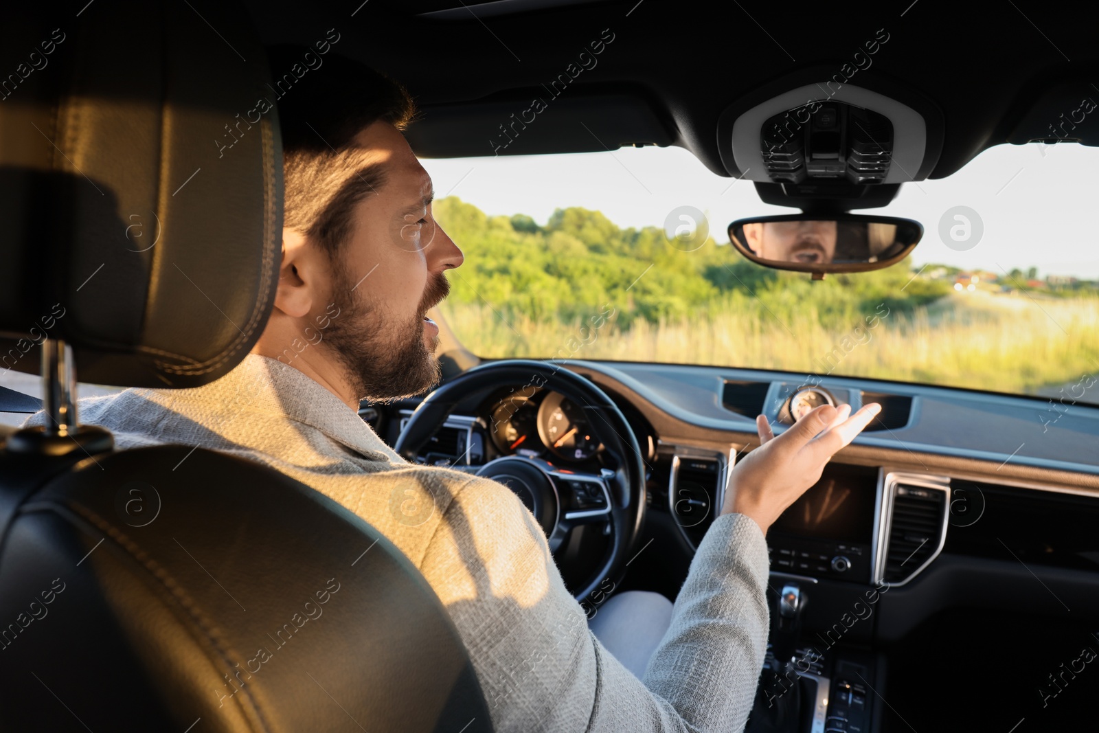 Photo of Man singing in car, view from inside
