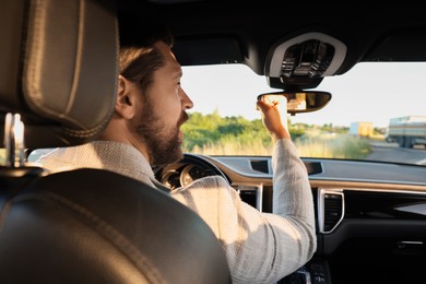 Photo of Man singing in car, view from inside