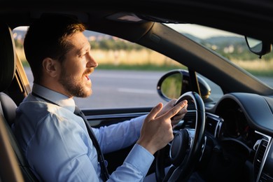 Photo of Man singing in car, view from inside