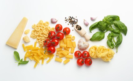 Photo of Different types of pasta, spices and products on white background, top view