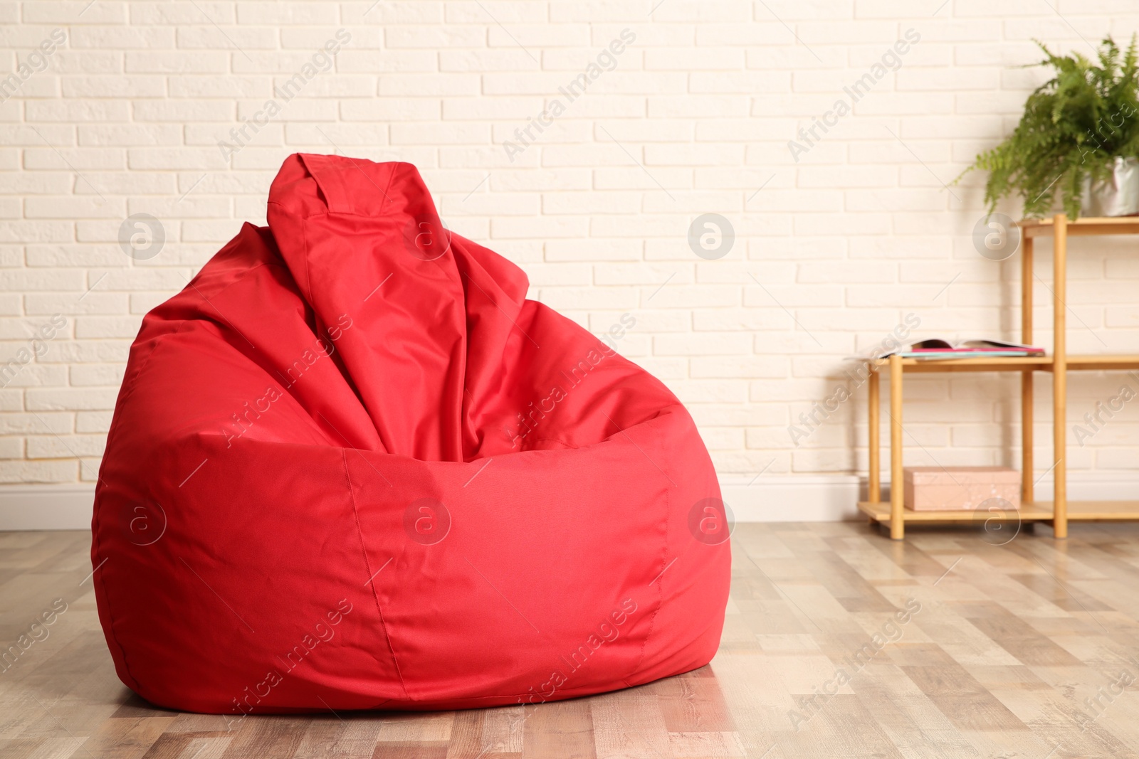 Photo of Red bean bag chair on floor in room