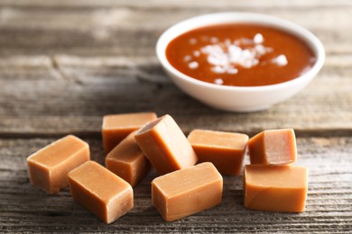 Photo of Yummy caramel candies on wooden table, closeup