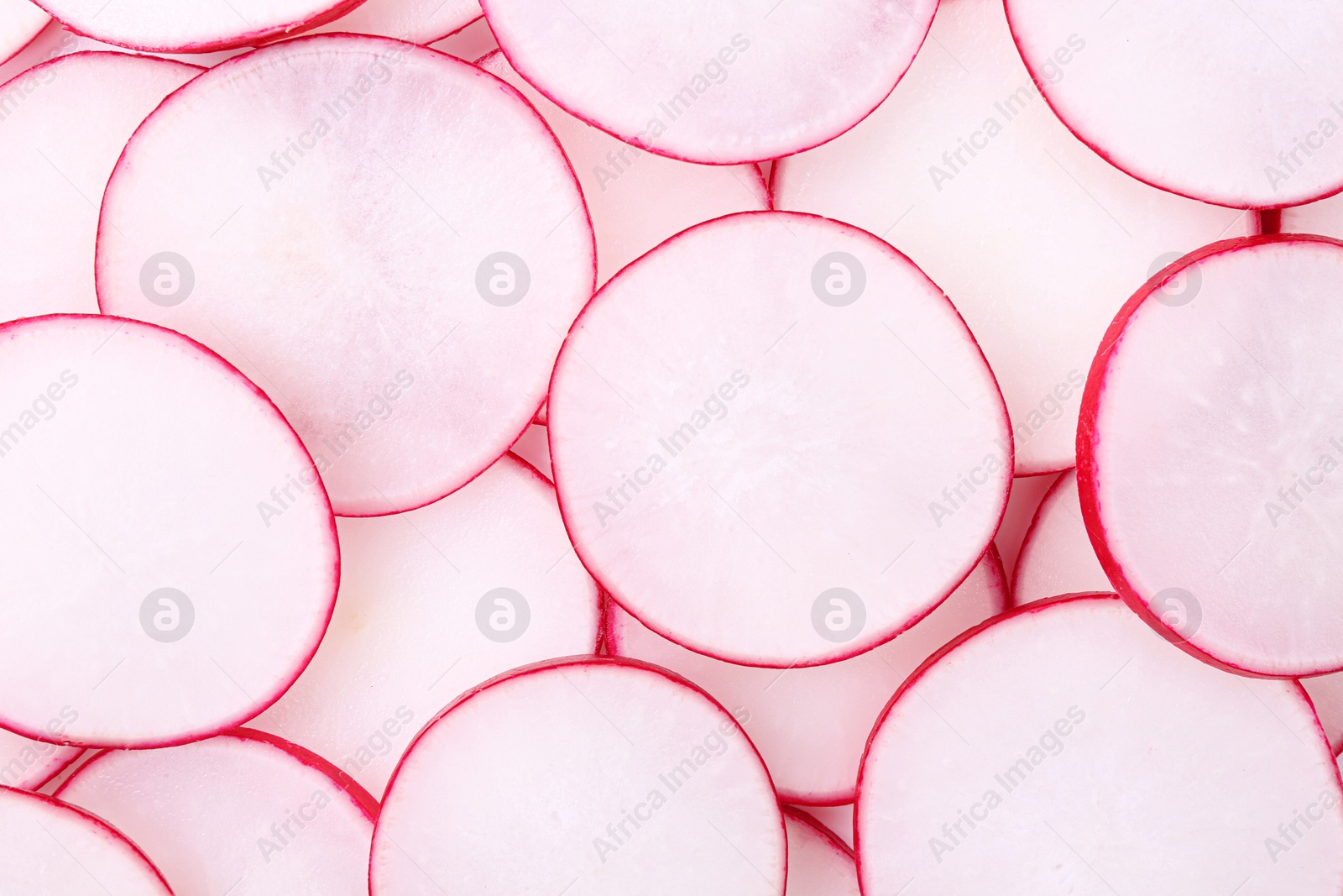 Photo of Slices of fresh ripe radish as background, top view