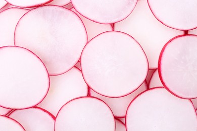 Photo of Slices of fresh ripe radish as background, top view