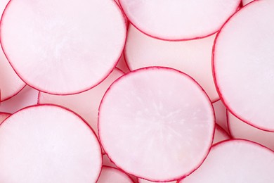 Photo of Slices of fresh ripe radish as background, top view