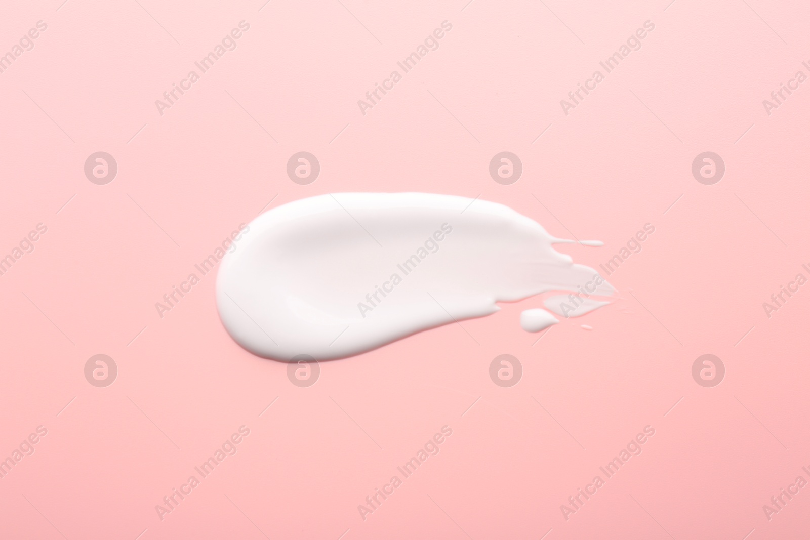 Photo of Sample of face cream on pink background, top view