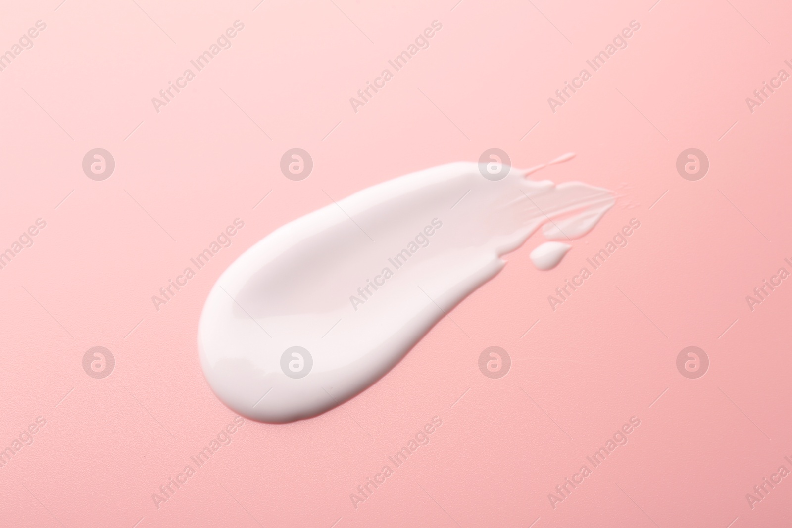 Photo of Sample of face cream on pink background, top view