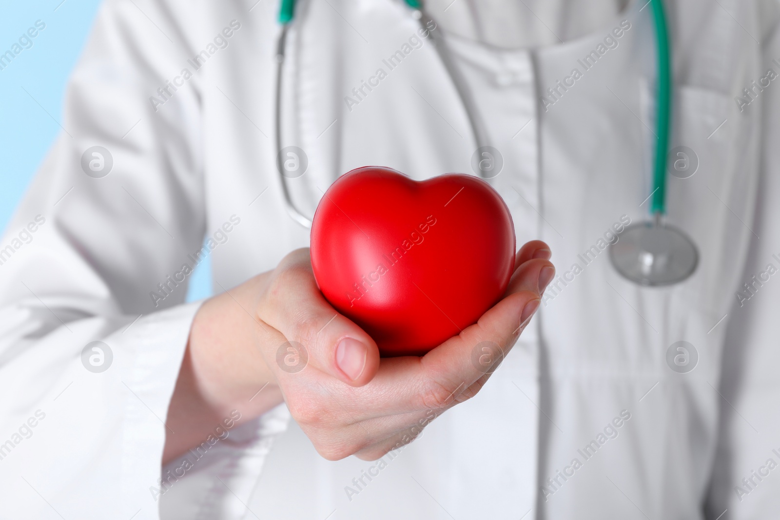 Photo of Doctor with red decorative heart, closeup view