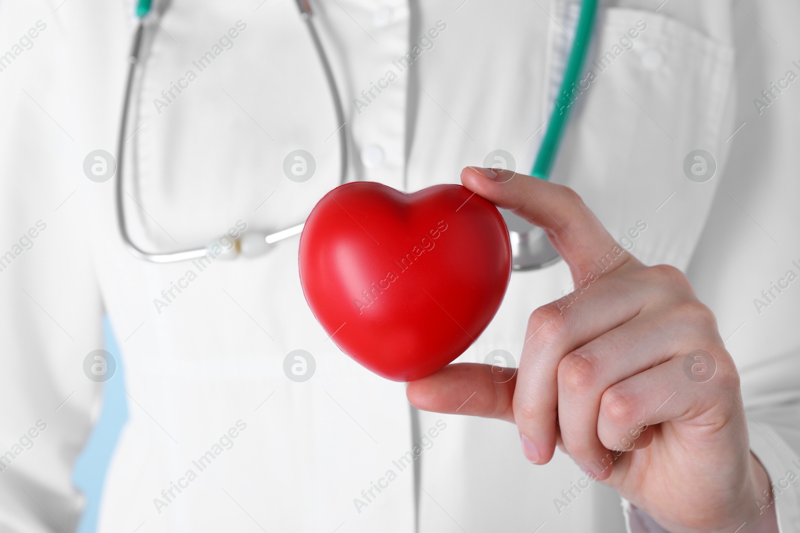 Photo of Doctor with red decorative heart, closeup view