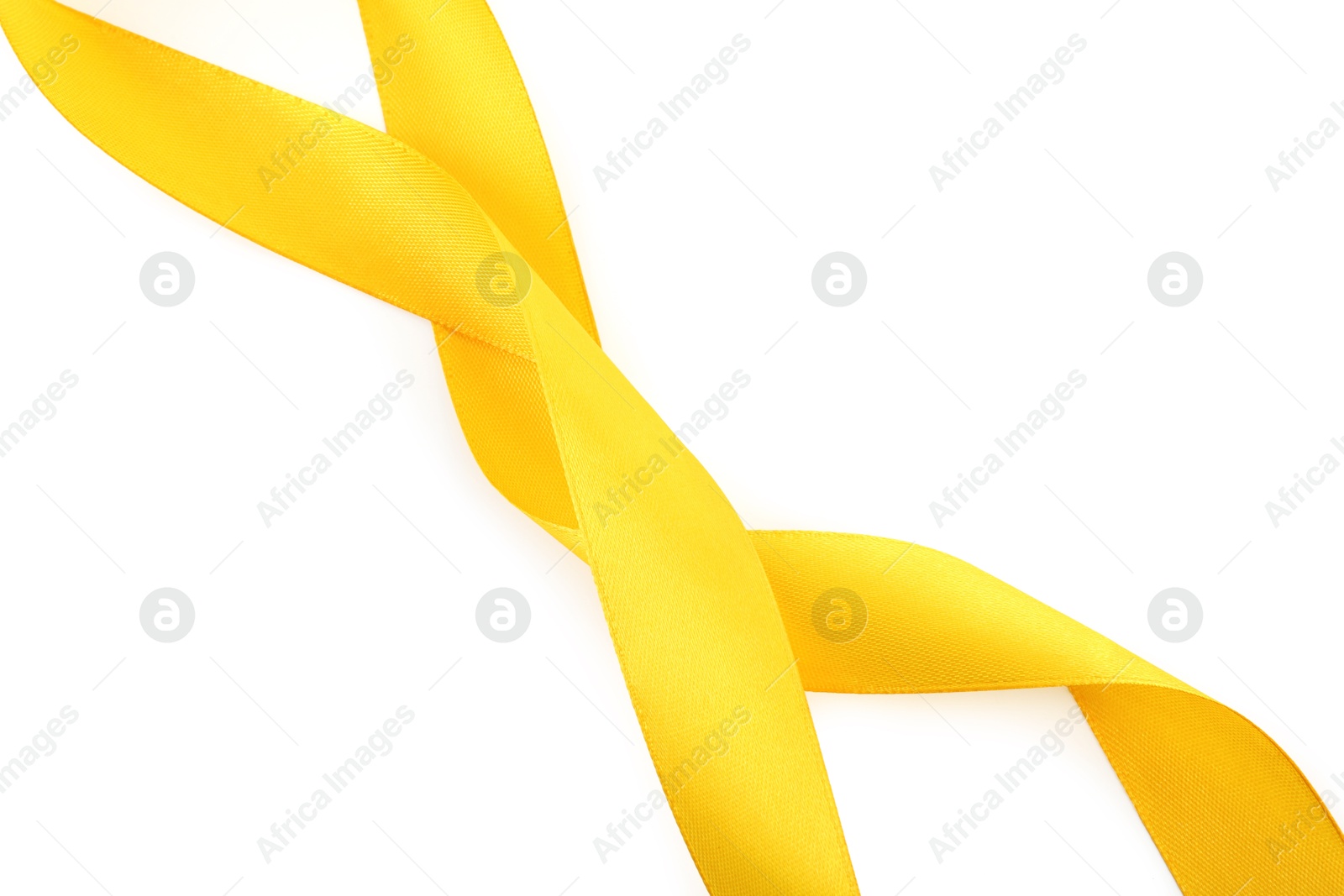 Photo of One beautiful yellow ribbon isolated on white, top view