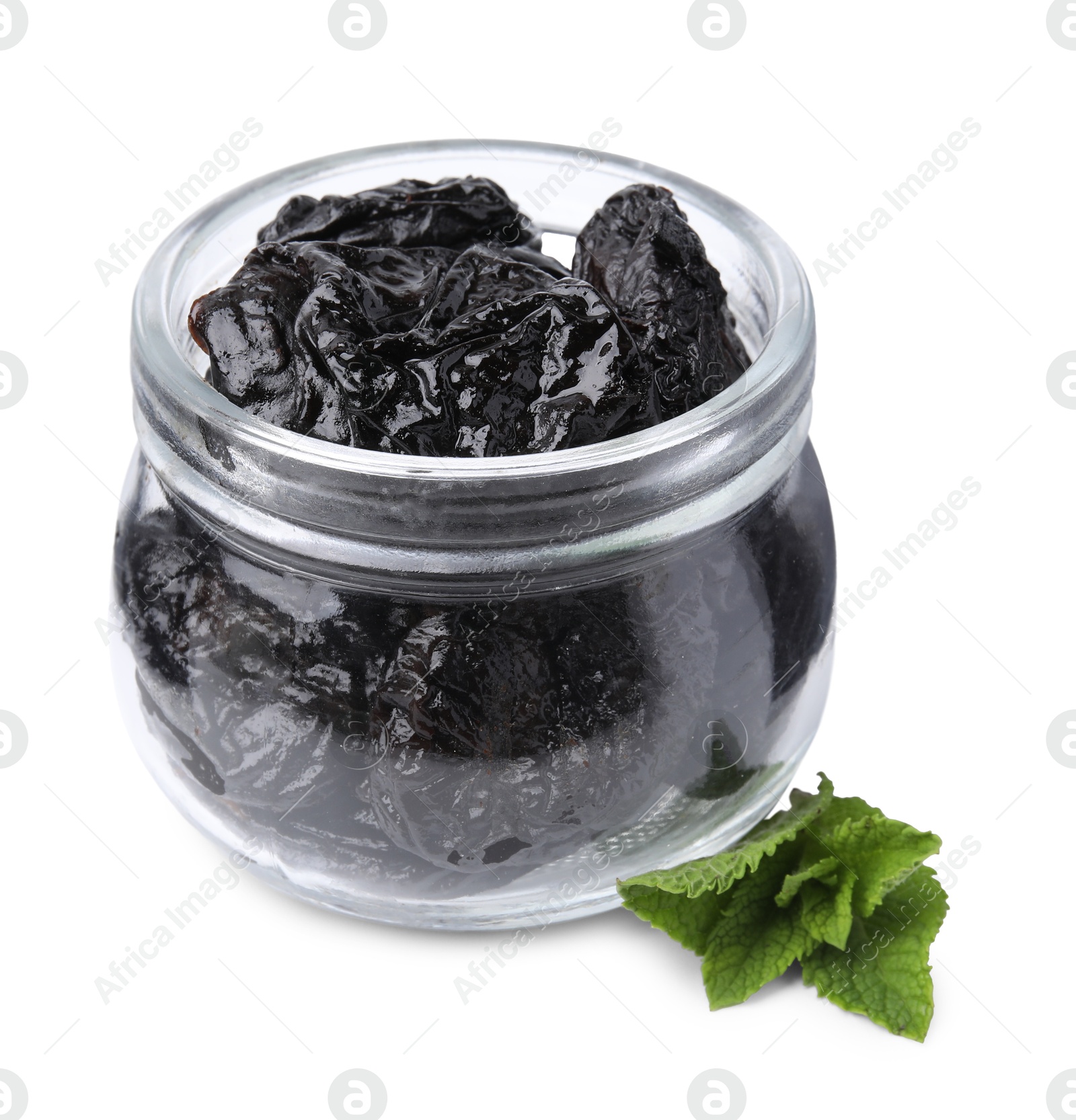 Photo of Tasty dried plums (prunes) in glass jar and mint leaves on white background